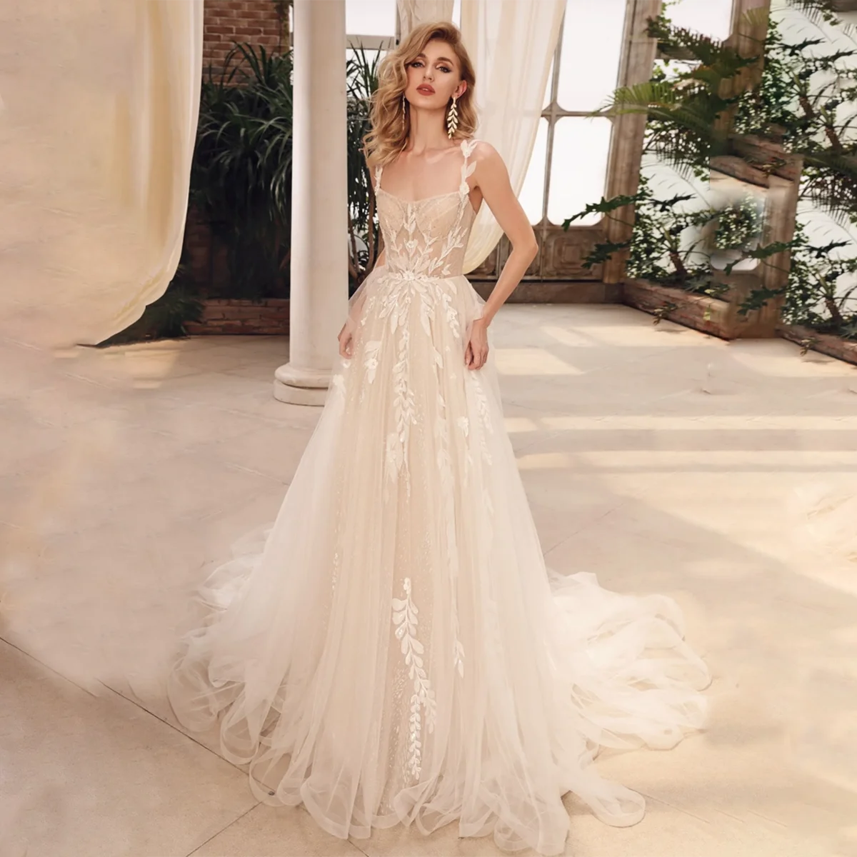 Introducing the gorgeous Robe Millie! Made with shimmering mesh and intricate embroidered lace, this dress will make you feel like a real princess on your wedding day. The sleeveless sweetheart bodice and sheer cami top add a touch of romantic elegance. Say "I do" in style with this A-line dream dress.