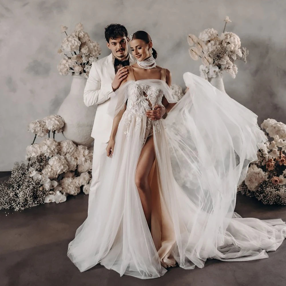 Elevate your wedding day with the Robe Satine, designed with seduction in mind. The off shoulder, high split design is delicately adorned with tulle appliques, shirred sleeves, and intricate beading lace. Its silhouette is perfect for maternity photoshoots and will make you feel like a goddess on your special day.