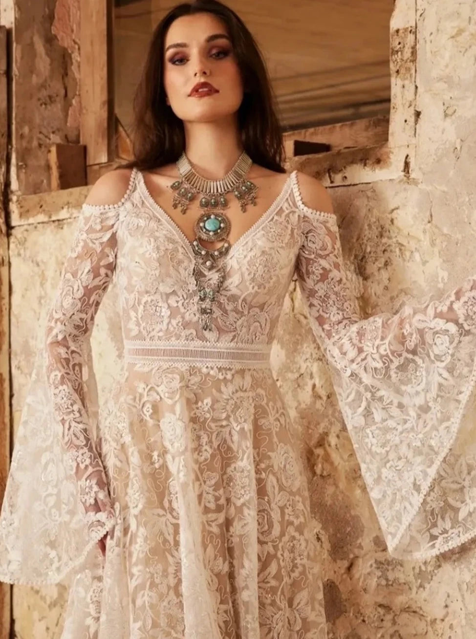 Indulge in the ethereal beauty of our Robe Vivien. This exquisite bridal gown features an empire V-neck, sweep floor length, cut-out open back, and delicate lace detailing. Elegantly crafted for your special day, it exudes grace and sophistication. Feel like a goddess on your wedding day with Robe Vivien.