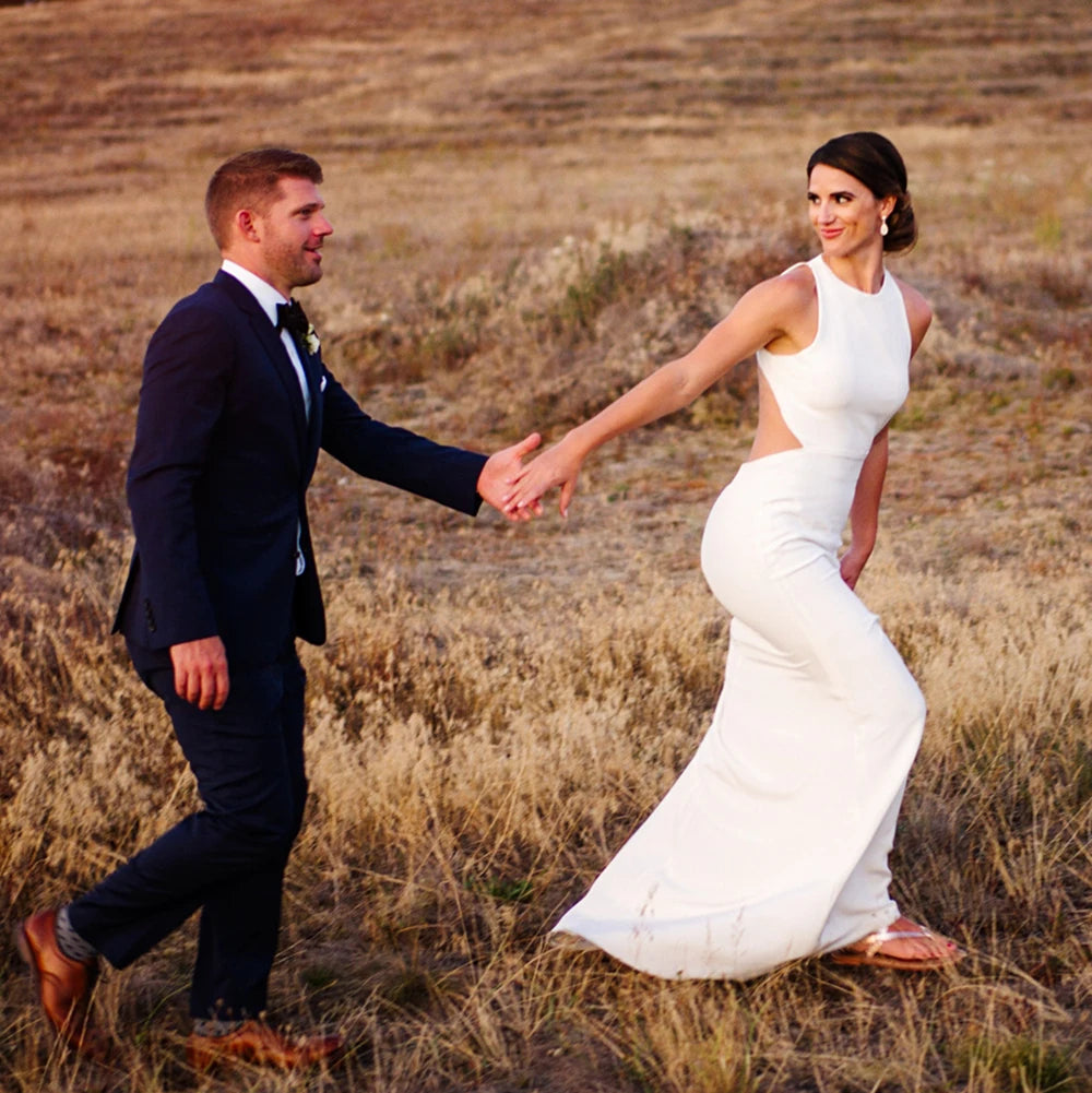 Walk down the aisle in style and comfort with our Dress Ghislaine. This stunning wedding dress features a round neck halter and a beautiful open back design, all made from high-quality satin crepe fabric. Its stretchy sheath silhouette and custom fit make it perfect for plus-size brides looking for a minimalist and elegant look on their special day.