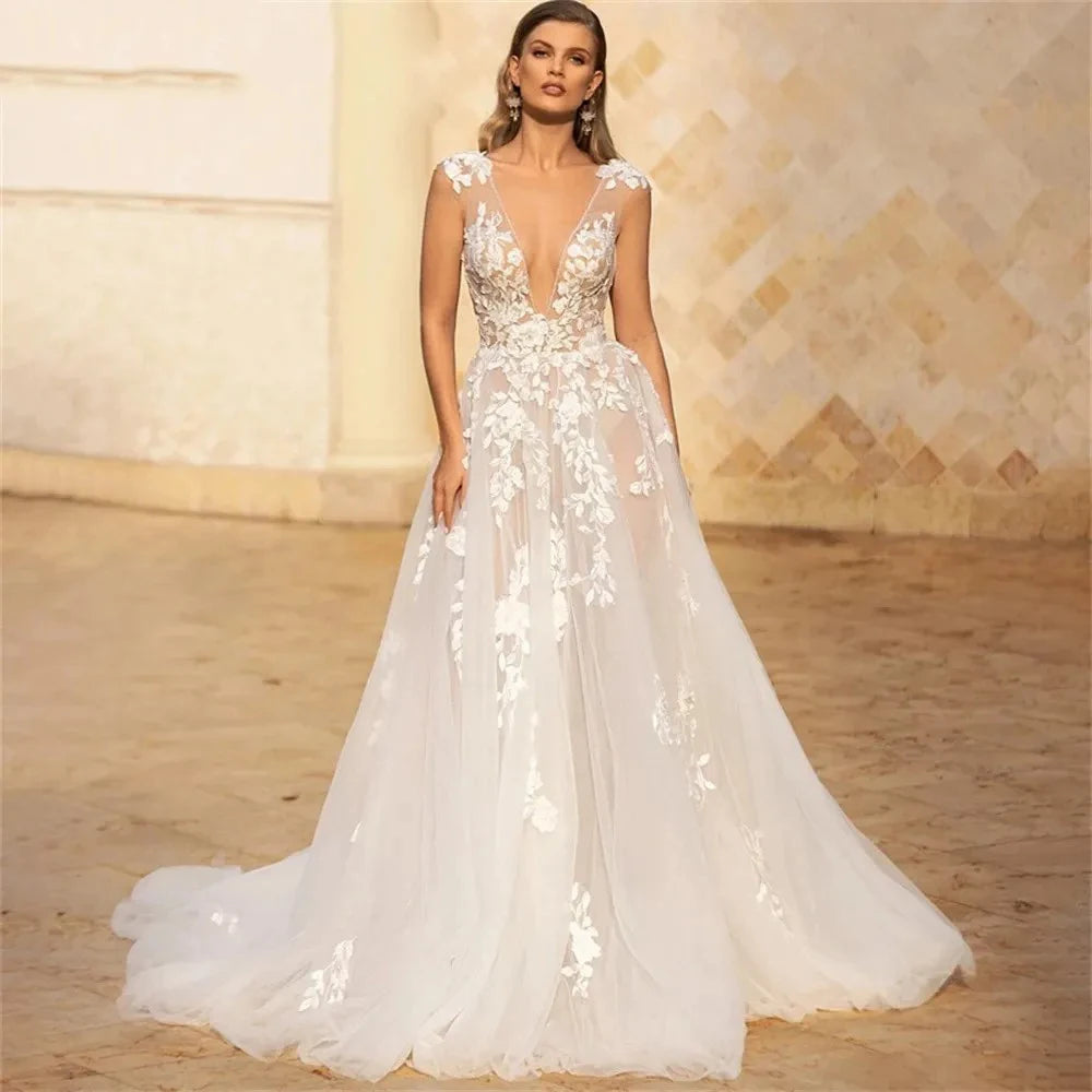 Indulge in luxury with the Robe Dior - a stunning bridal dress featuring cap sleeves and a backless design, all adorned with intricate floral and leaf lace detailing. The A-line silhouette and tulle fabric make this dress both elegant and comfortable, making it the perfect choice for your special day.