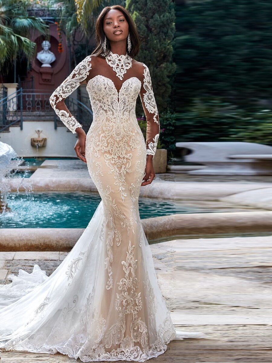 Embark on a journey of discovery and style with the Robe Odette. Crafted with a high neckline and mermaid silhouette, this wedding dress ensures your bridal look is as bold as your love story. Show them the beauty of risk-taking with an unforgettable look.