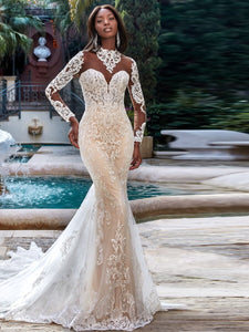 Embark on a journey of discovery and style with the Robe Odette. Crafted with a high neckline and mermaid silhouette, this wedding dress ensures your bridal look is as bold as your love story. Show them the beauty of risk-taking with an unforgettable look.