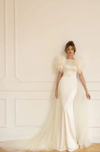 The beautiful boheme Robe Eloise is a one-of-a-kind bridal gown that combines sophistication and modernity in perfect harmony. With its unique scoop sleeve design and luxurious fabric, this robe is sure to add a touch of elegance to your special day.