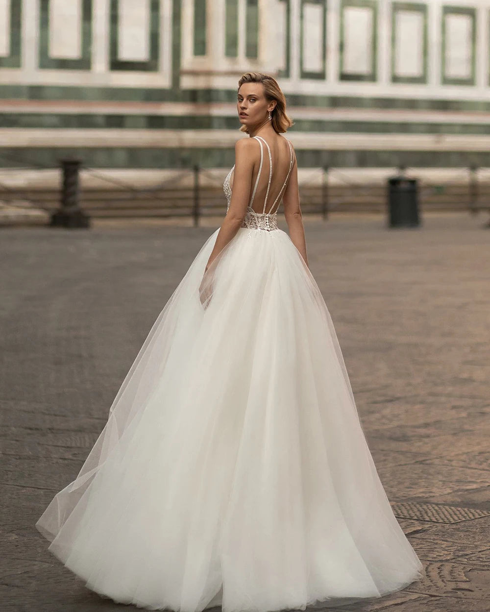 Indulge in pure elegance with the Robe Emeraude. This wedding dress features a seductive V-neck, delicate lace and luxurious tulle fabric, and a stunning backless design fit for a princess. Perfect for the sophisticated bride who wants to make a statement on her special day.