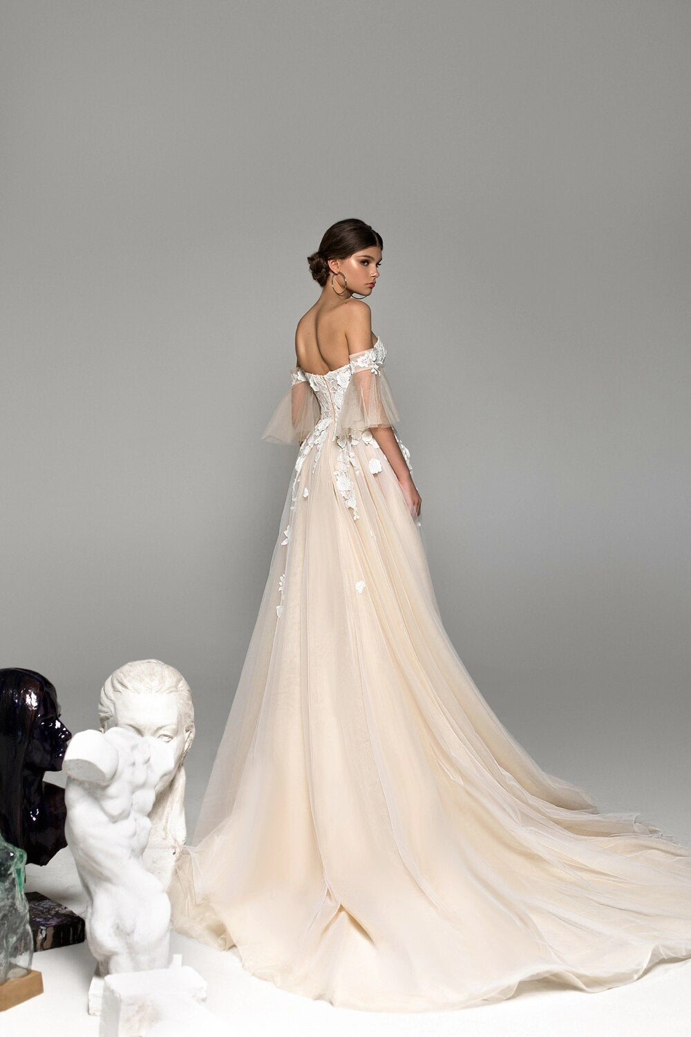 Elevate your bridal look with the Remy Gown. Featuring sweetheart neckline appliques, a chapel train, and a stunning silhouette, it's your chance to make a bold statement on your special day. Dare to be unique!