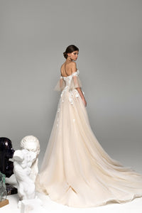 Elevate your bridal look with the Remy Gown. Featuring sweetheart neckline appliques, a chapel train, and a stunning silhouette, it's your chance to make a bold statement on your special day. Dare to be unique!