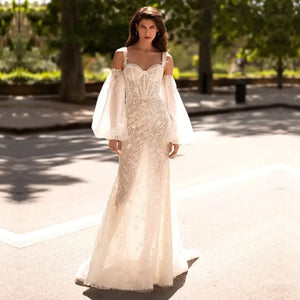 Exude timeless elegance in the Robe Seraphine, a luxurious sweetheart neckline sheath bridal gown. Delicately crafted from premium lace fabric and featuring delicate spaghetti straps, flattering long sleeves and a flattering puff silhouette, this sophisticated and classic piece is the perfect way to make a truly refined statement on your special day.