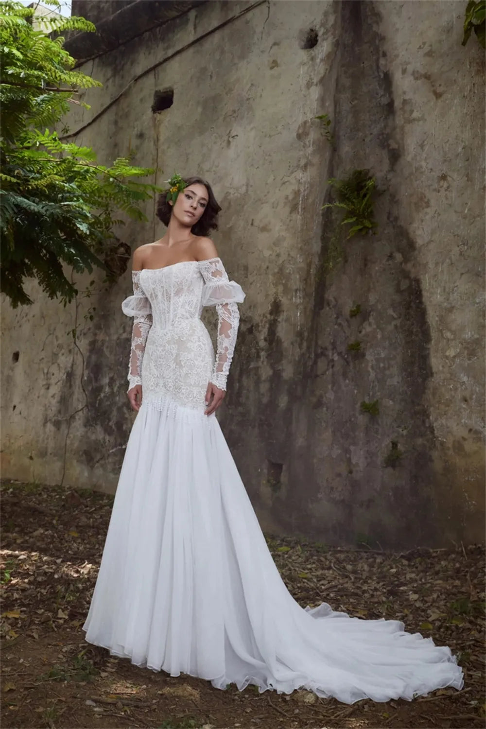 Experience true luxury with the Sabine Robe. This eye-catching floor-length gown features a beautiful mermaid silhouette with a sexy bateau neckline, a daring cut-out open back, and glimmering lace appliqués. Slay the aisle in this statement-making ensemble fit for royalty!