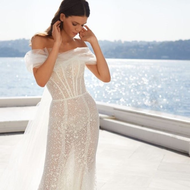 Look like a queen in our stunning Jessie Robe! Illuminating the room with its mermaid lace and off-the-shoulder silhouette, this bridal gown will make you feel like you're ready to rule the night. So, don your crown and get ready for the royal treatment you deserve!