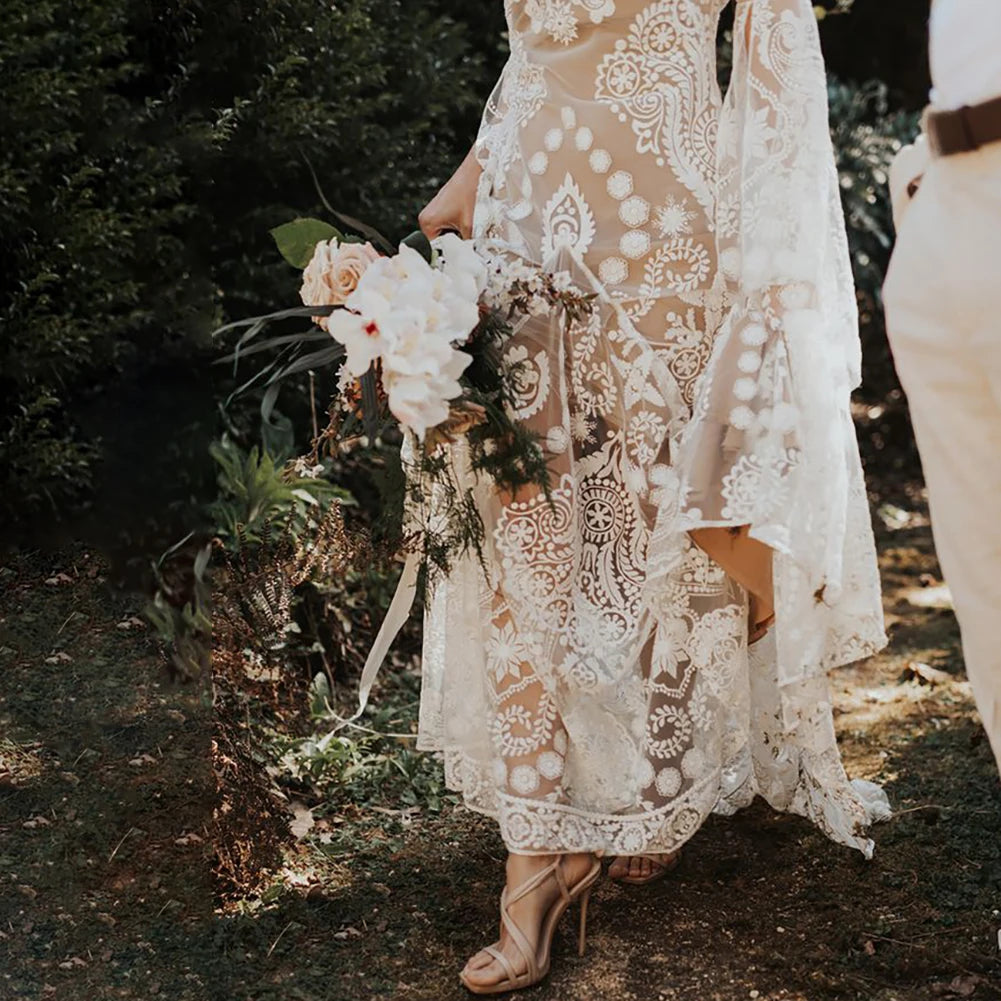 Expertly crafted for the modern and elegant bride, the Robe Anaise features delicate lace detailing and a sleek, form-fitting silhouette. Its long batwing sleeves and high neck add a touch of bohemian flair, while the custom made double slip with slit ensures comfort and movement on the big day. Complete your bridal look with this two-piece, backless sheath gown.