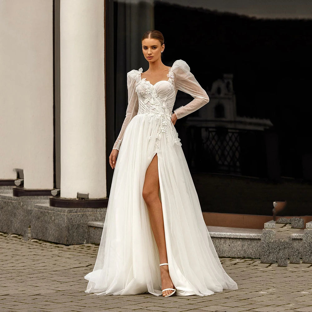 Indulge in luxury with our Robe Sixtine. This elegant Boho wedding dress features delicate lace appliques, an open back, and intricate beading. The long sleeves add a touch of sophistication while the floral details evoke the beauty of a royal wedding. Make a statement on your special day.