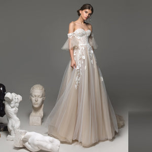 Elevate your bridal look with the Remy Gown. Featuring sweetheart neckline appliques, a chapel train, and a stunning silhouette, it's your chance to make a bold statement on your special day. Dare to be unique!