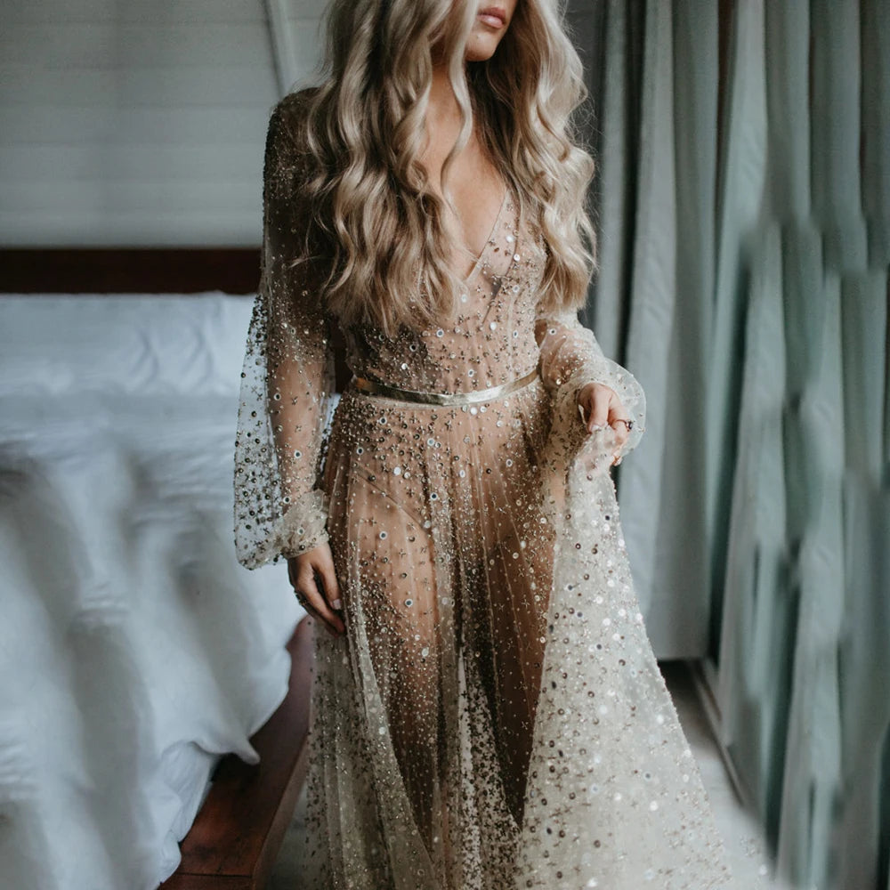 Indulge in the opulence of our Dress Carrie. This luxurious A-line gown boasts intricate beading, a see-through V-neckline, and a backless design. Adorned with sparkling Swarovski crystals and flowing layers of illusion tulle, it's a custom-made masterpiece fit for a bride's most special day.