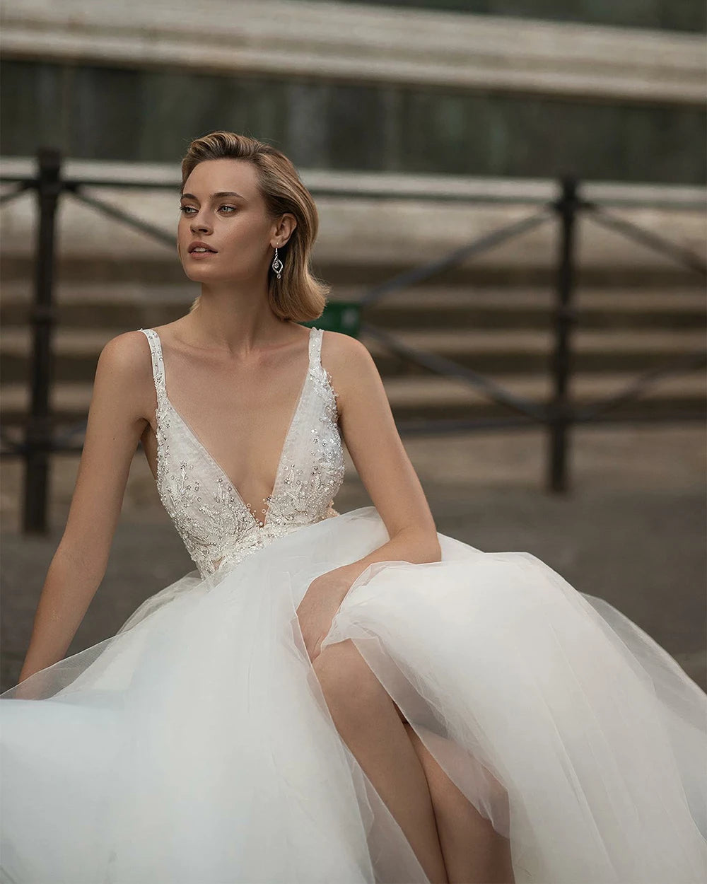 Indulge in pure elegance with the Robe Emeraude. This wedding dress features a seductive V-neck, delicate lace and luxurious tulle fabric, and a stunning backless design fit for a princess. Perfect for the sophisticated bride who wants to make a statement on her special day.