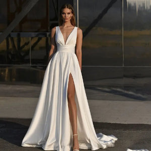 Get ready to stun in the Robe Zenna! This elegant wedding dress features a deep V-neck and backless design, perfect for those who want to make a statement. The spaghetti straps add a touch of delicacy, while the side slit and A-line cut flatter your figure. Feel like a goddess on your special day.