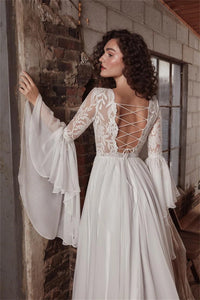 Indulge in luxury with the exquisite Dress Chamilla. This stunning wedding dress features an empire silhouette, elevated by a boat neckline and intricate lace detailing. The flowing chiffon fabric adds a touch of romance, making it the perfect choice for bridal gowns. Walk down the aisle in style and grace.