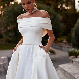 This stunning off-the-shoulder mermaid wedding dress exudes elegance and sexiness. With its flattering silhouette and mopping design, it's perfect for any bride who wants to make a statement on her special day. Make your wedding unforgettable with Dress Amelia!