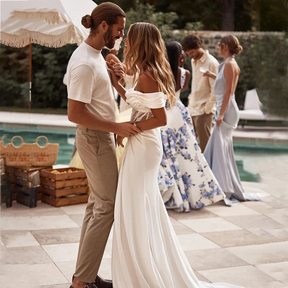 Introducing the Dress Ava - the perfect blend of luxury and simplicity. With a beautiful sweetheart neckline, off-shoulder lace detail, and mermaid silhouette, this dress is sure to fascinate and captivate. Make your wedding day even more special with the enchanting Dress Ava.