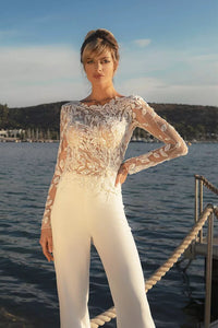 Experience the feminine grace of the Combinaison Nadine exquisite wedding gown. Embellished with opulent appliques and a detachable train, this elegant jumpsuit will make you the center of attention. Enjoy the timeless glamour of luxury fashion on your special day.