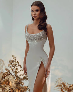 Elevate your bridal look with the exquisite Robe Ninon. This sexy, detachable train wedding dress boasts intricate beadwork and a shiny square neck for a touch of luxury. Embrace the allure and sophistication of this one-of-a-kind gown, perfect for the modern bride on her special day.