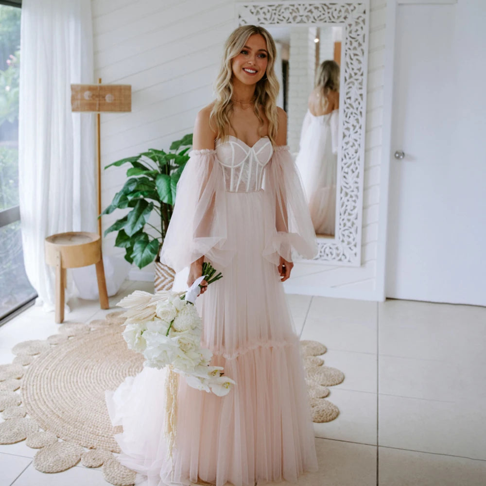 Make a statement in the Robe Amalie! This bold wedding gown features princess sweetheart neckline, long bishop sleeves, boning, lace overlay, and a tulle skirt for a look that'll take your breath away. Step into this dress with confidence and get ready to make your own fairy tale.