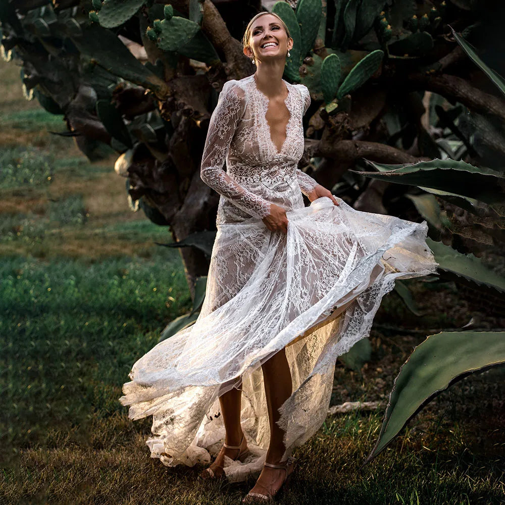 Capture a sophisticated look for your special day with the Robe Esme. Crafted in sheer lace, this plus size A line wedding gown features deep v neckline, long sleeves and boho maxi hipple design for a rustic yet luxe look. Perfect for photography, the dress is custom made to ensure a perfect fit. Create a timeless bridal look with Robe Esme.