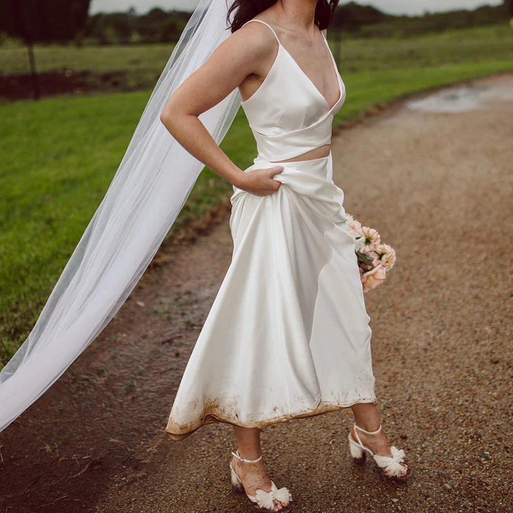 Turn heads at your special day with this exquisite two-piece robe chance dress! Boasting spaghetti straps, a custom made Sheath V Neck and a backless design, this timeless minimalist dress is perfect for any bride looking to make a lasting statement. Crafted from luxurious crepe fabric for ultimate comfort and style, this gorgeous crop top is sure to make your grand entrance memorable!
