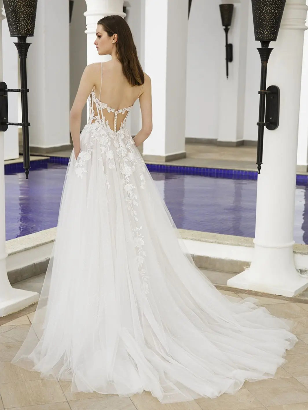 Get ready to stun in our Dress Bella! This A-line bridal gown features a plunging sweetheart neckline, exposed corset, and illusion cut-outs for a daring yet elegant look. The high split adds a touch of drama, making you the show-stopper on your special day.