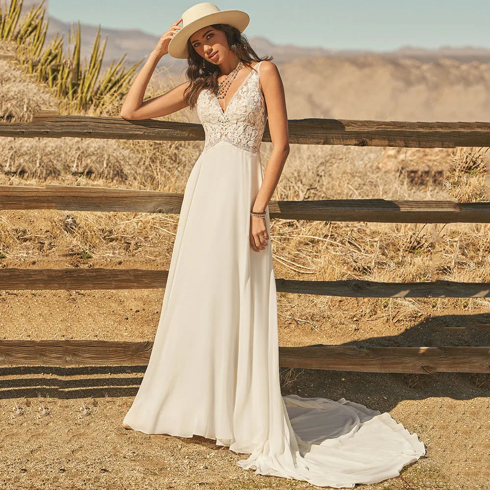 The Dress Scarlett is a stunning bohemian wedding dress designed with a V-neck and delicate lace appliques. The A-line silhouette and flowy chiffon fabric add an ethereal touch, while the backless design and button train bring a modern and romantic twist. Perfect for a boho bride looking for a unique and beautiful gown.