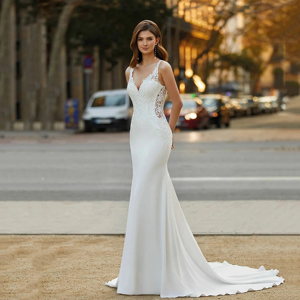 Make a splash on your big day with the Robe Desi. This elegant lace mermaid wedding dress is perfect for the boho bride, featuring a satin bodice and sleeveless design. Show off your curves and dance the night away in this stunning and unique gown.