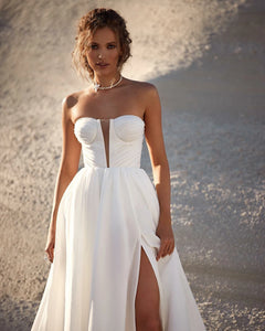 Looking for the perfect beach wedding dress? Look no further! Our Robe Angelique features an elegant deep V-neck design that will make you stand out on your special day. With its lightweight and flowy fabric, you'll feel comfortable and chic as you say "I do" with the ocean as your backdrop.