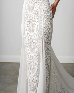 Indulge in the romantic allure of the Robe Perrine. This bohemian-inspired lace wedding dress is both simple and elegant, with a mermaid cut that effortlessly flatters your figure. The delicate lace adds a touch of sophistication, making you feel like a true siren on your special day.