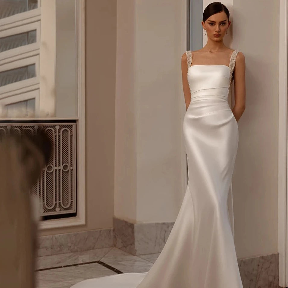 Indulge in luxury with our Robe Angeline. This bridal gown features a square neckline and elegant beading, perfectly complimented by a removable train. The custom cutouts and backless design add a touch of sophistication. Make a memorable entrance on your special day with the Robe Angeline.
