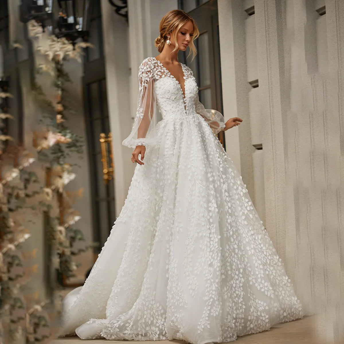 Robe Marian is an exquisite masterpiece, crafted from luxurious mesh tulle with delicate embroidery. The intricate details of the 3D lace and open back create a timeless silhouette, while the long puffy sleeves, low V neckline and custom fit bring out the best of your figure. Perfect for the most special occasions, this gown will make you look and feel truly radiant.