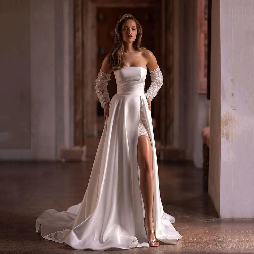 Elevate your bridal look with our Robe Noémie. Crafted with shimmering sequins and delicate beading, this satin dress exudes sophistication. The detachable train offers versatility, while the off the shoulder design adds a touch of romance. Perfect for the modern bride looking for a statement dress.