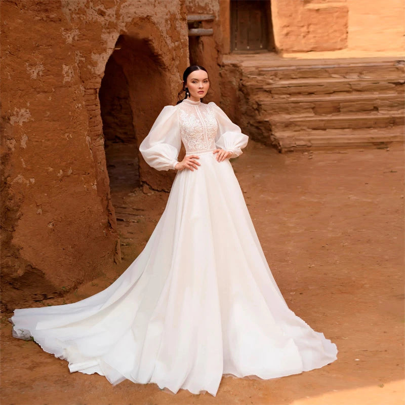 Get ready to shine on your special day with the Robe Lune! This elegant ivory white wedding dress features beautiful bubble long sleeves and high work embroidery, making it perfect for a haute couture look. You'll feel like a true bride in this stunning bridal gown. Order now and make your wedding day unforgettable!