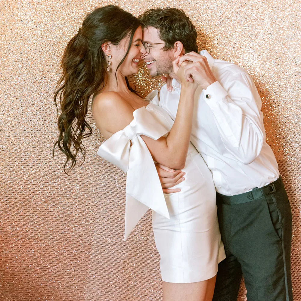 Look dreamy in this Mini Bridal Robe Lisette! Featuring a simple satin sheath fit with bow and custom-made elastic straps, you'll be the glamourous star of the show on your special day. Slip into this above-knee beauty and feel like the queen you are!