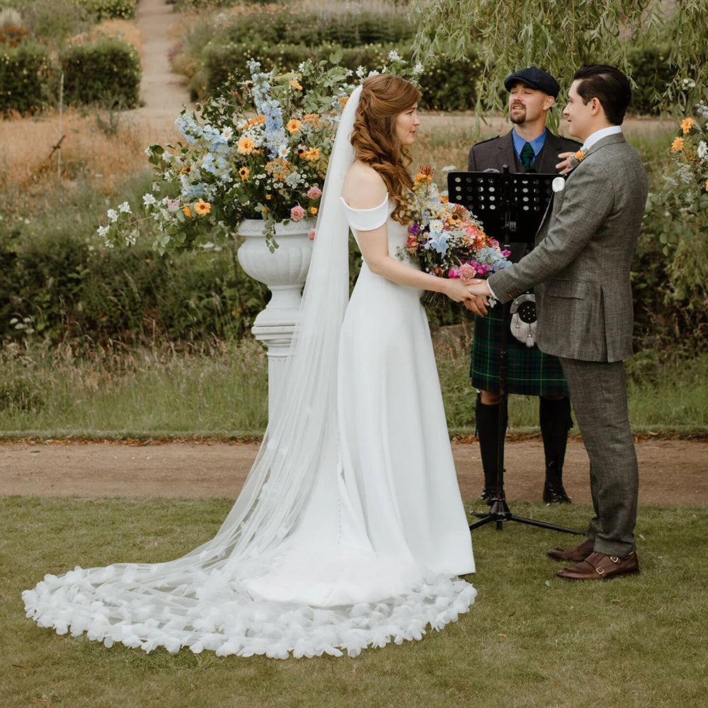 Indulge in the romance of a fairytale wedding with the Bloom Flowers Romantic Wedding Dress Michelle. This custom-made off-white mesh veil comes with a delicate blusher that adds elegance to your bridal look. The comb headpiece adds a touch of glamour and compliments your beauty on your special day.