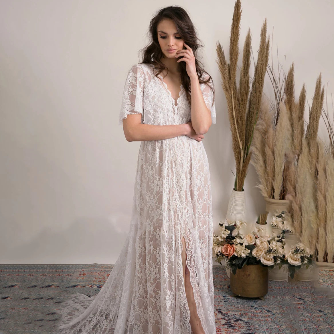 Feel like a boho princess in the Dress Vanille! Perfect for beach weddings, this dress features a V-neck, flutter sleeves, and a sheer back with delicate lace details. The high split adds a touch of elegance to this whimsical and playful design. Say 'I do' in style!