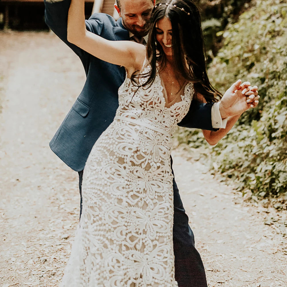 Effortlessly elegant, our Robe Nalini wedding dress features a boho-inspired cutout lace design with a flattering mermaid silhouette. Designed to be customized for plus-size brides, this dress also boasts a stunning hollow open back and long sleeves, creating a truly romantic and unique look for your special day.