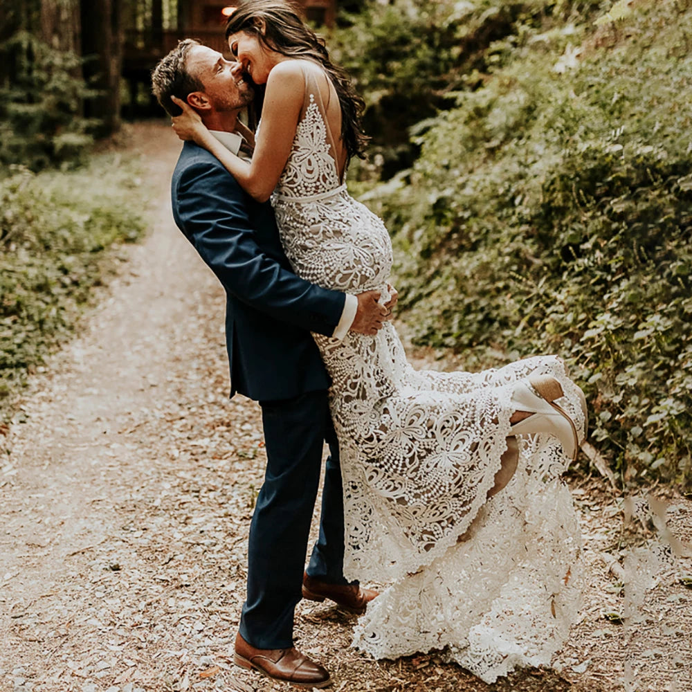 Effortlessly elegant, our Robe Nalini wedding dress features a boho-inspired cutout lace design with a flattering mermaid silhouette. Designed to be customized for plus-size brides, this dress also boasts a stunning hollow open back and long sleeves, creating a truly romantic and unique look for your special day.