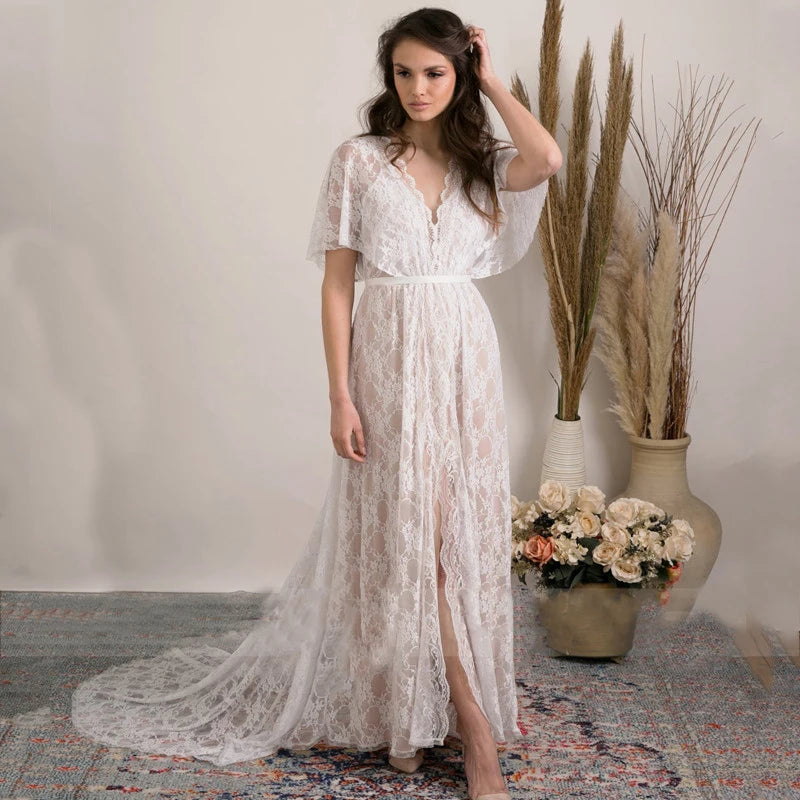 Feel like a boho princess in the Dress Vanille! Perfect for beach weddings, this dress features a V-neck, flutter sleeves, and a sheer back with delicate lace details. The high split adds a touch of elegance to this whimsical and playful design. Say 'I do' in style!