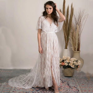 Feel like a boho princess in the Dress Vanille! Perfect for beach weddings, this dress features a V-neck, flutter sleeves, and a sheer back with delicate lace details. The high split adds a touch of elegance to this whimsical and playful design. Say 'I do' in style!