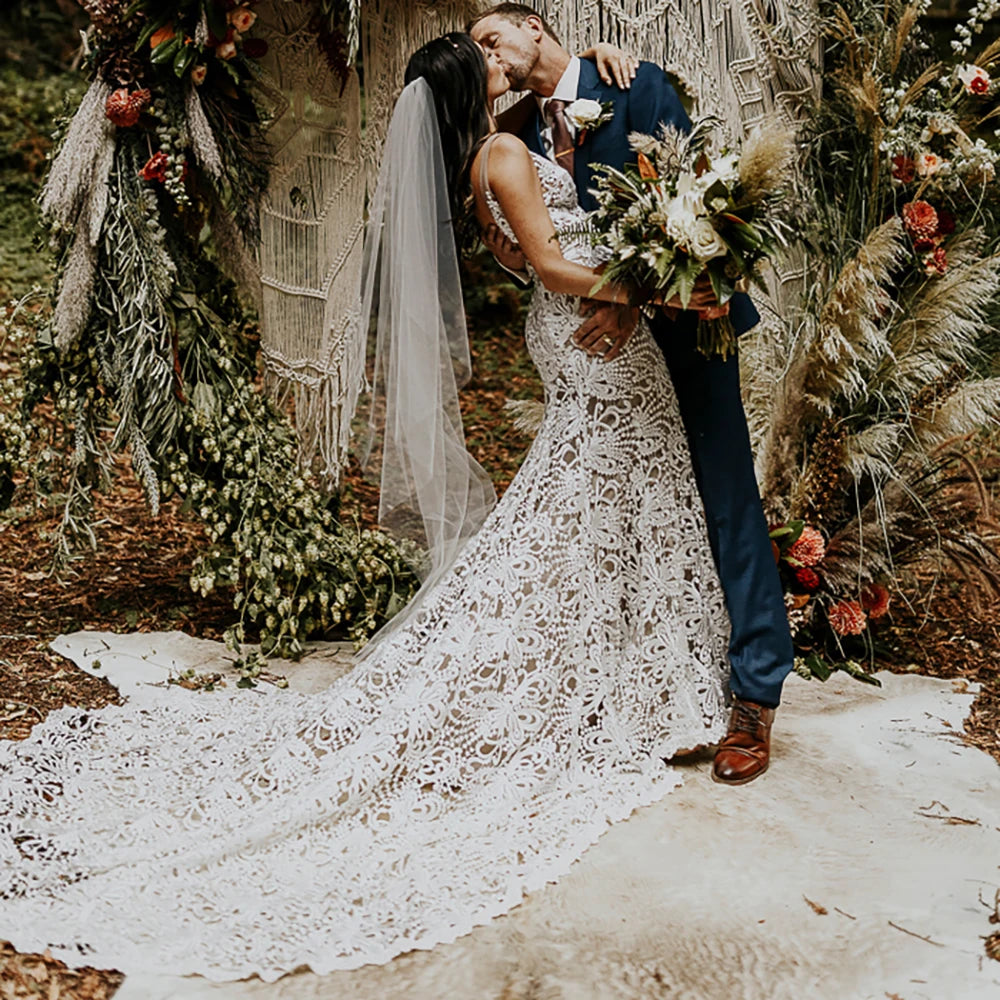 Effortlessly elegant, our Robe Nalini wedding dress features a boho-inspired cutout lace design with a flattering mermaid silhouette. Designed to be customized for plus-size brides, this dress also boasts a stunning hollow open back and long sleeves, creating a truly romantic and unique look for your special day.