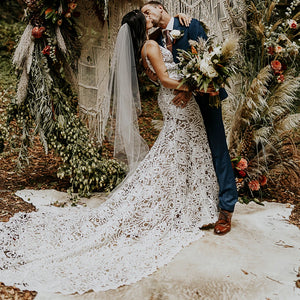 Effortlessly elegant, our Robe Nalini wedding dress features a boho-inspired cutout lace design with a flattering mermaid silhouette. Designed to be customized for plus-size brides, this dress also boasts a stunning hollow open back and long sleeves, creating a truly romantic and unique look for your special day.