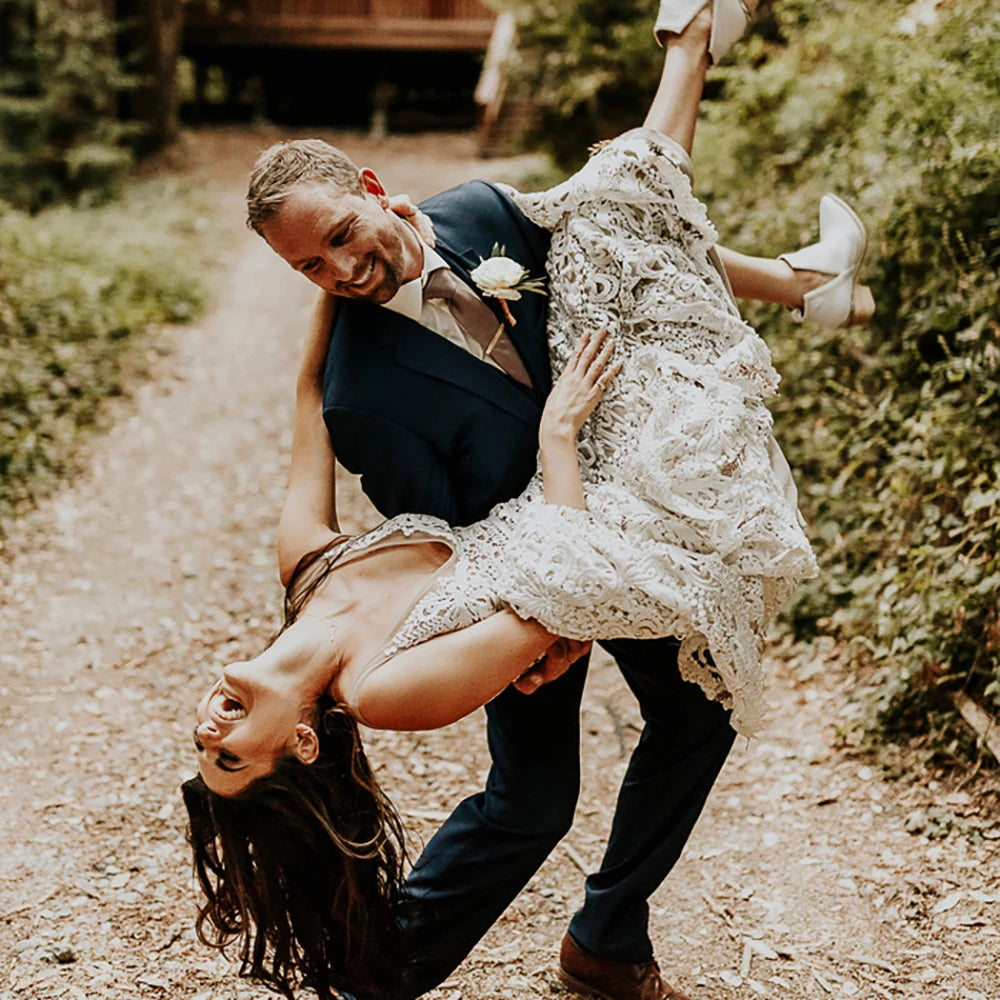Effortlessly elegant, our Robe Nalini wedding dress features a boho-inspired cutout lace design with a flattering mermaid silhouette. Designed to be customized for plus-size brides, this dress also boasts a stunning hollow open back and long sleeves, creating a truly romantic and unique look for your special day.