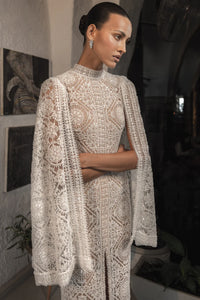 Make a statement on your special day with the Milana Dress. This stunning bridal gown boasts elegant embroidery for a touch of romance and sophistication. Step into your wedding with grace and style in this one-of-a-kind dress.