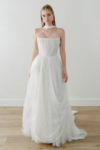 Introducing the Bridget Corset Gown, a modern twist on the timeless ballgown silhouette. With its soft net tie and Georgian-style corsetry, this gown exudes romance and structure. Delicate tucks add an element of intrigue, creating a unique and elegant creation that embodies contemporary style. Crafted from soft netting, the Bridget Corset Gown is a perfect blend of modern and classic design.
