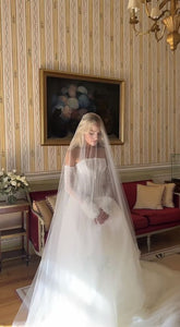 Elevate your special day with the captivating Robe Hannah. This elegant bridal gown exudes sophistication and grace, making you feel stunning as you walk down the aisle. Let its timeless design and flawless fit enhance your beauty and create timeless memories.